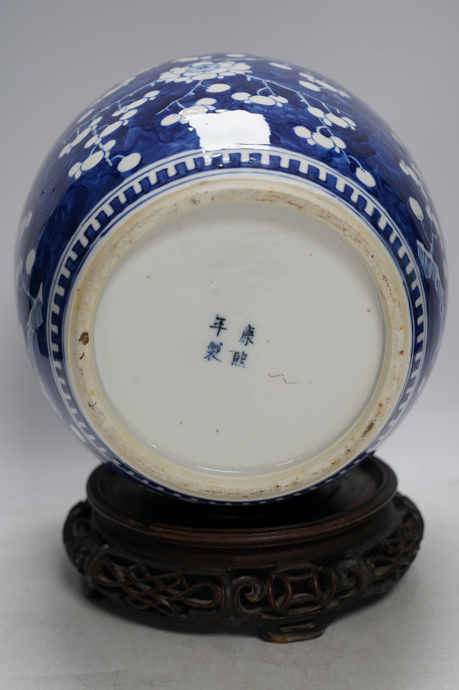 A 19th century Chinese blue and white ginger jar with hardwood stand and cover, overall 30cm high. Condition - jar and stand good, cover repaired